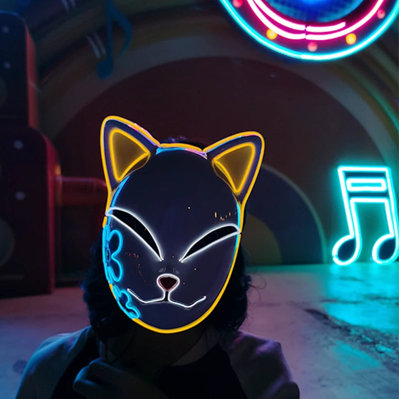 Person wearing a neon cat mask in front of a colorful, neon-lit background