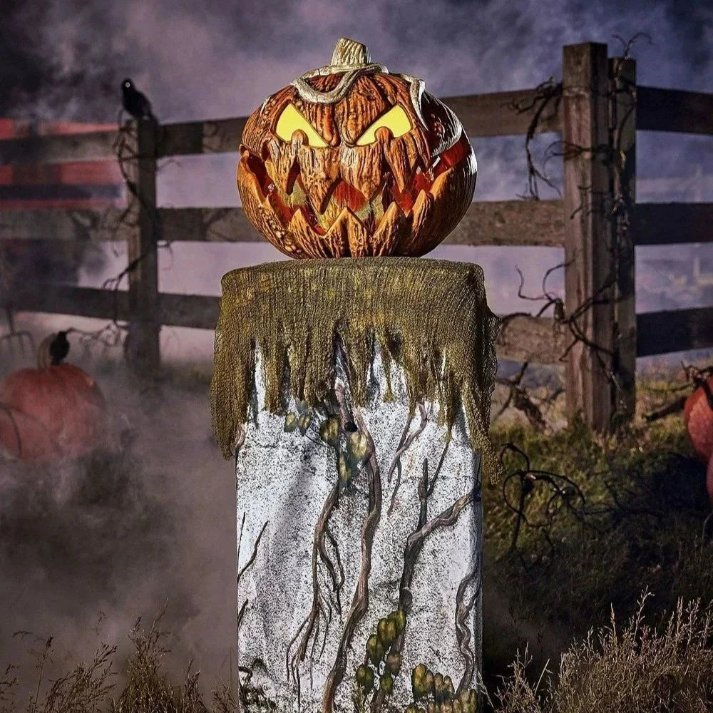 pumpkin with carved face on a stand