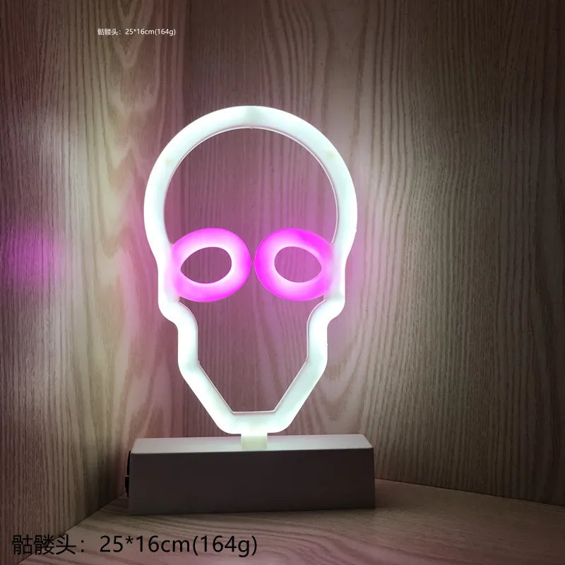Neon light shaped like a skull with pink eyes on a wooden surface