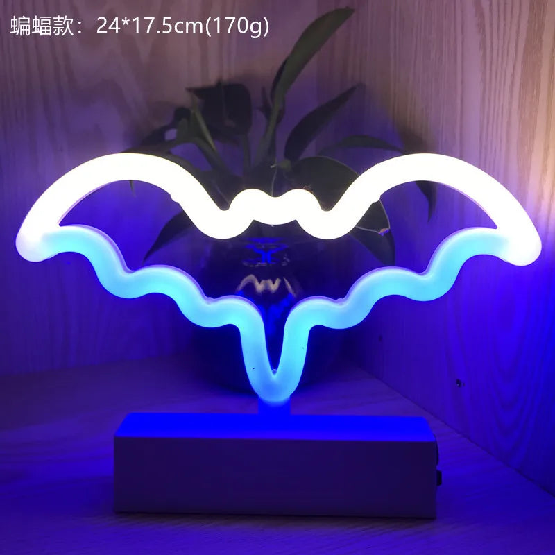 Neon bat-shaped lamp with blue and white colors on a dark background