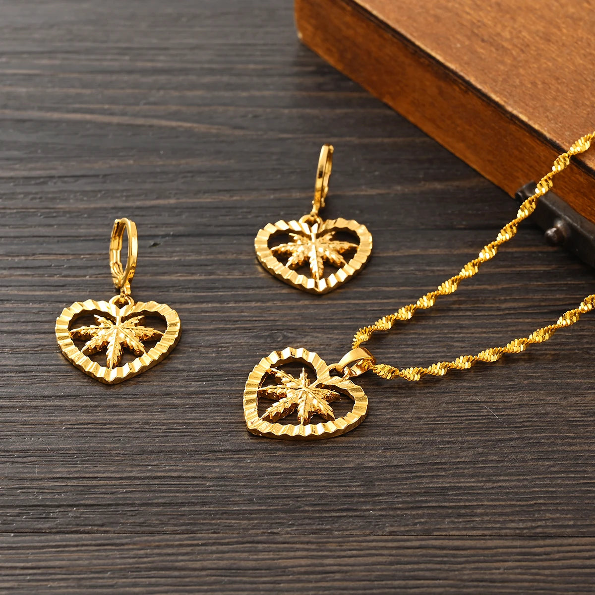 Gold heart-shaped pendants on a wooden surface