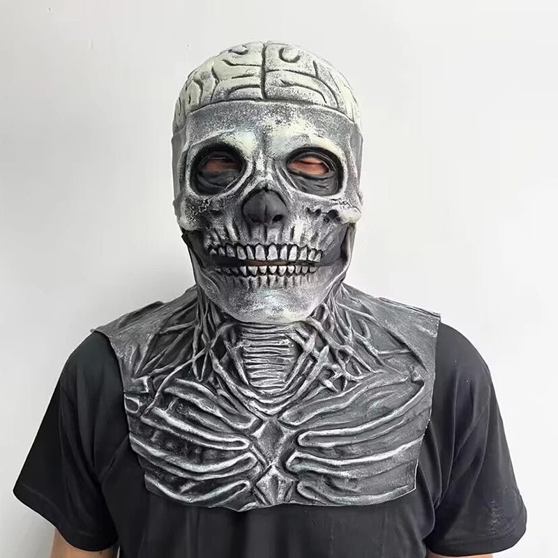 Person wearing a detailed skeleton mask and costume against a white background
