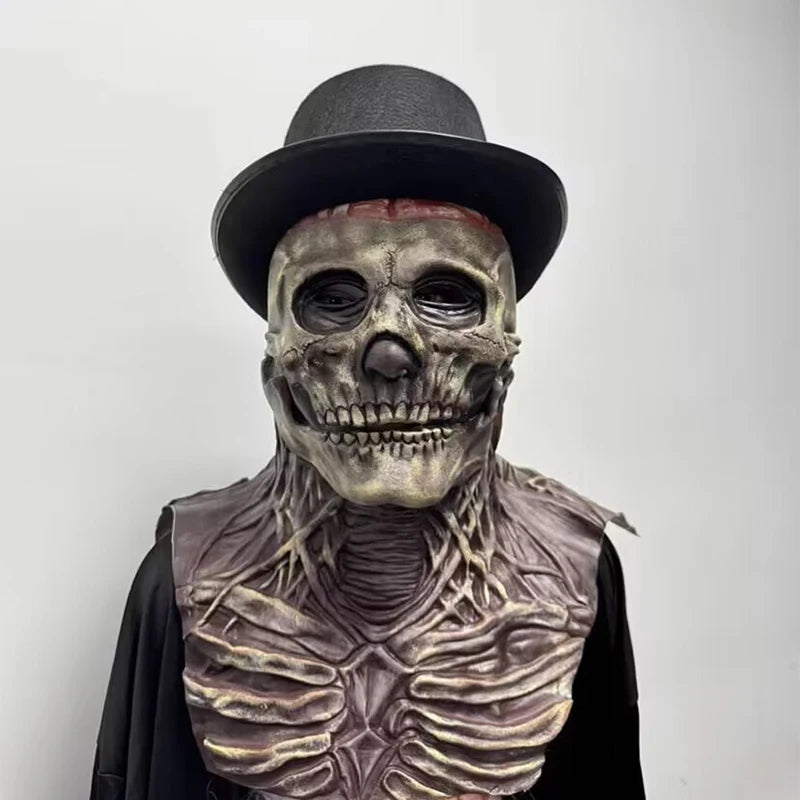 Person wearing a skeleton costume with a top hat on a plain background