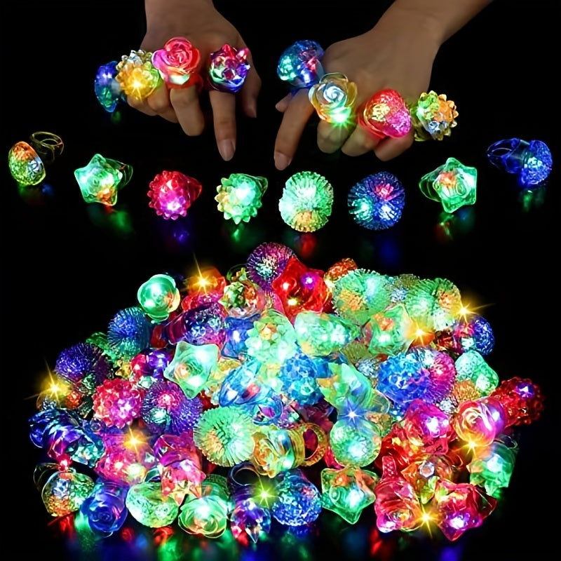 Colorful LED rings on hands and scattered on a dark background